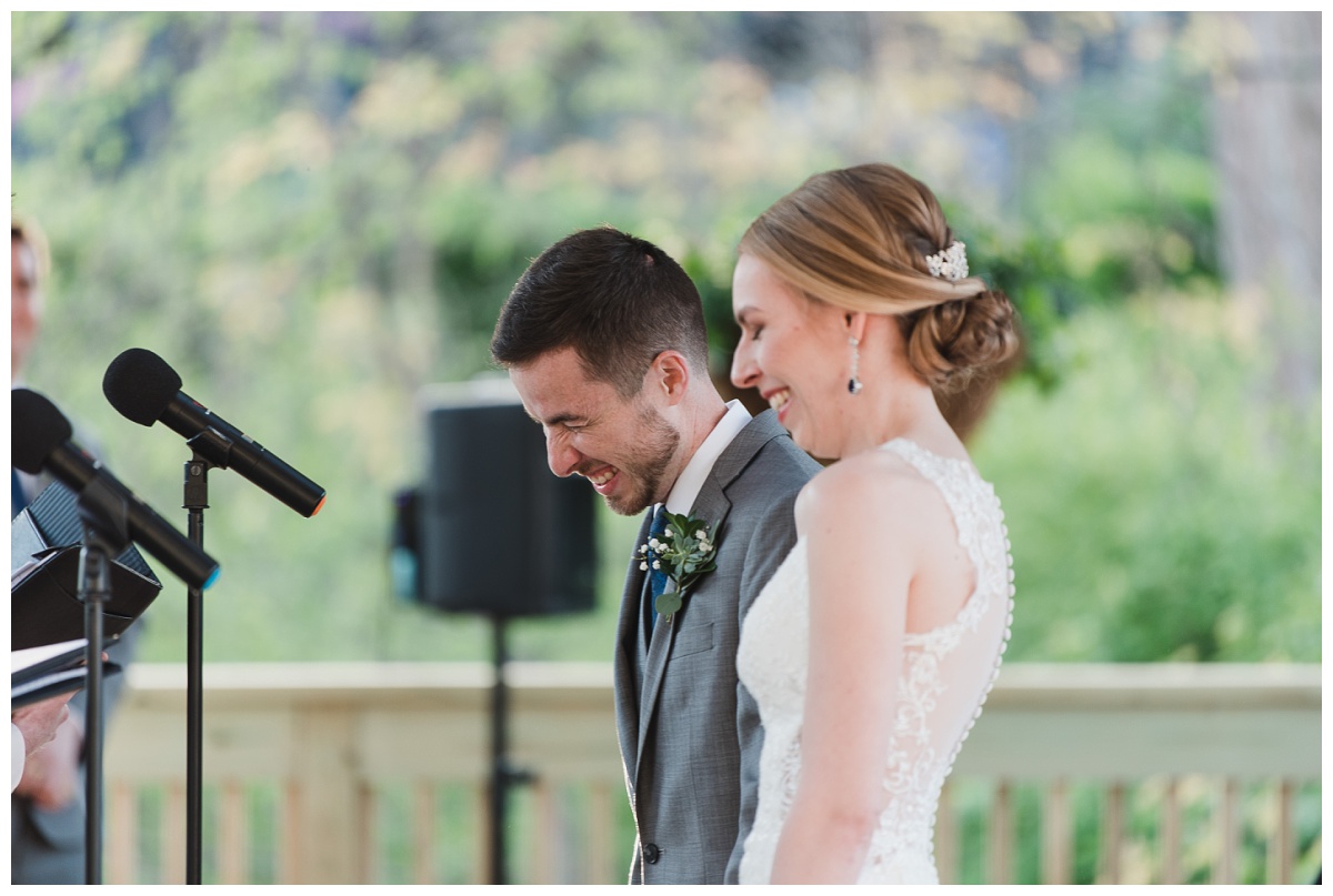 bride and groom laughing during ceremony at St. Louis Zoo, wedding photography by Sandra Grunzinger Photography