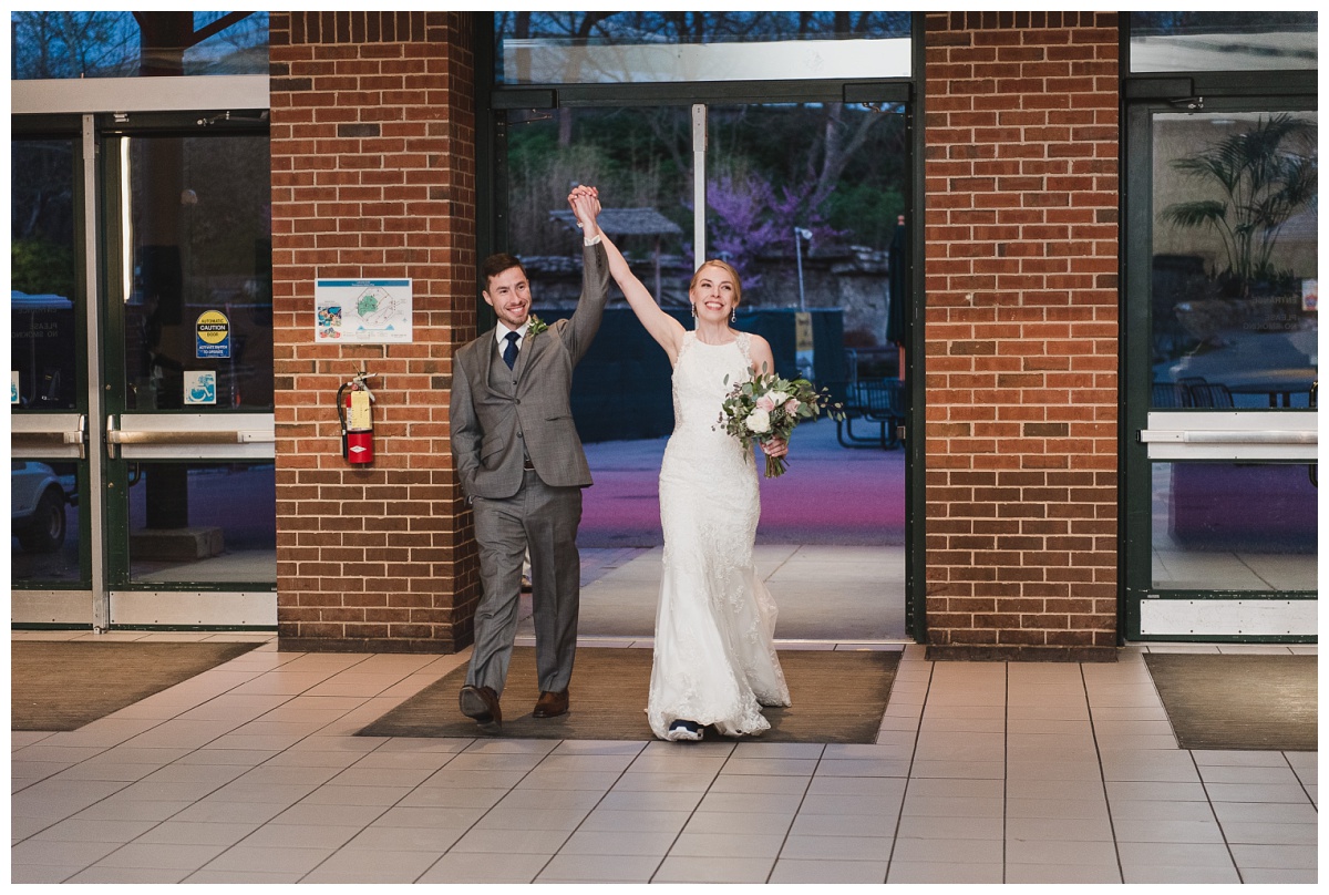 Bride and groom entering the Lakeside Cafe for their reception at the St. Louis Zoo, wedding photography by Sandra Grunzinger Photography