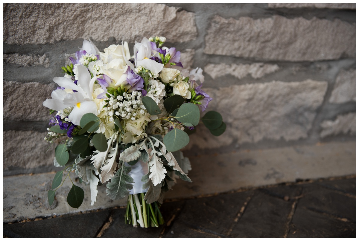 White, green and lilac rose iris bouquet by Linda of Walter Knoll Florist at Stone House of St Charles, a St Louis wedding venue